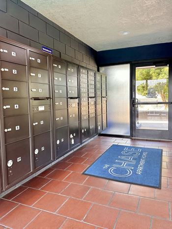 Mailroom with wall mounted boxes and floor mat